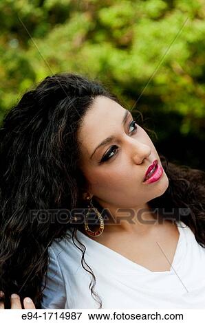 Profile portrait of a 21 year old woman with long cury black hair View Large Photo Image Stock Photo - Profile portrait of a 21 year old woman with long cury black hair. Fotosearch