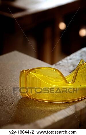 Stock Image - Protection glasses on the working table. Fotosearch