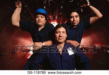 Stock Photo - Proud factory workers. Fotosearch