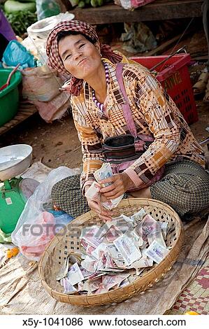 Proud woman at the Skuom Market showing off her money View Large Photo Image Stock Photograph - Proud woman at the Skuom Market showing off her money. Fotosearch
