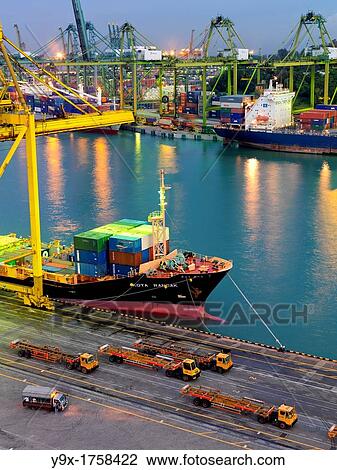 PSA Singapore Terminals is the world largest container transhipment hub, handling about one-fifth of the world's total container transhipment throughput View Large Photo Image Stock Image - PSA Singapore Terminals is the world largest container transhipment hub, handling about one-fifth of the world's total container transhipment throughput. Fotosearch