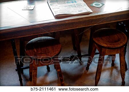 Pub table with two stools and a newspaper in Yorkshire Dales, England, UK, Europe. View Large Photo Image Stock Image - Pub table with two stools and a newspaper in Yorkshire Dales, England, UK, Europe.. Fotosearch