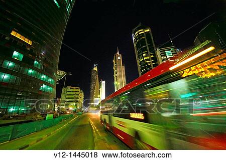 Public bus on the streets of downtown Kuwait City at night. Kuwait View Large Photo Image Stock Photo - Public bus on the streets of downtown Kuwait City at night. Kuwait. Fotosearch