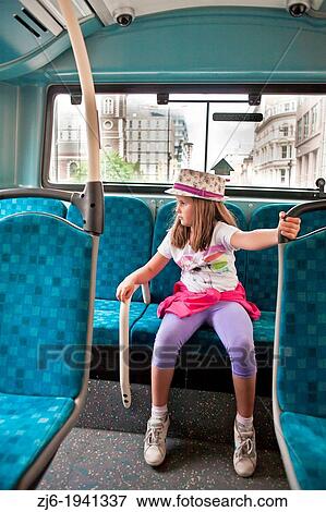 Stock Photo - Public transport. Girl in bus. London.. Fotosearch