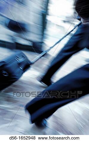 Pulling trolley case, blurred image View Large Photo Image Stock Photo - Pulling trolley case, blurred image. Fotosearch