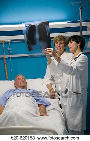 Stock Photo - Pulmonologist with patient and relative. Urgencias, Hospital de Zumarraga, Gipuzkoa, Euskadi. Spain.. Fotosearch