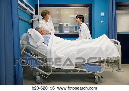 Stock Photograph - Pulmonologist with patient and relative. Urgencias, Hospital de Zumarraga, Gipuzkoa, Euskadi. Spain.. Fotosearch