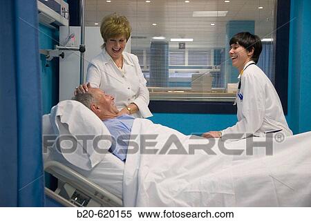 Stock Photography - Pulmonologist with patient and relative. Urgencias, Hospital de Zumarraga, Gipuzkoa, Euskadi. Spain.. Fotosearch
