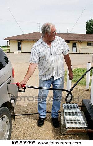 Pumpimg gas in a small village gas station View Large Photo Image Stock Photography - Pumpimg gas in a small village gas station. Fotosearch