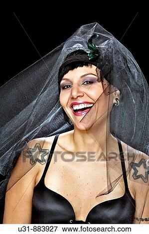 Punk Bride in her late 20s in a studio setting wearing a black wedding dress smiles View Large Photo Image Stock Photo - Punk Bride in her late 20s in a studio setting wearing a black wedding dress smiles. Fotosearch