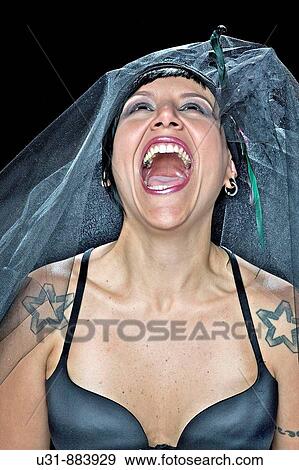 Punk Bride in her late 20s in a studio setting wearing a black wedding dress screaming View Large Photo Image Stock Photo - Punk Bride in her late 20s in a studio setting wearing a black wedding dress screaming. Fotosearch