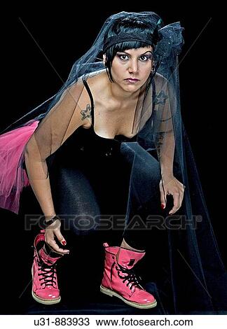 Punk Bride in her late 20s wearing a black dress in a studio setting View Large Photo Image Stock Image - Punk Bride in her late 20s wearing a black dress in a studio setting. Fotosearch