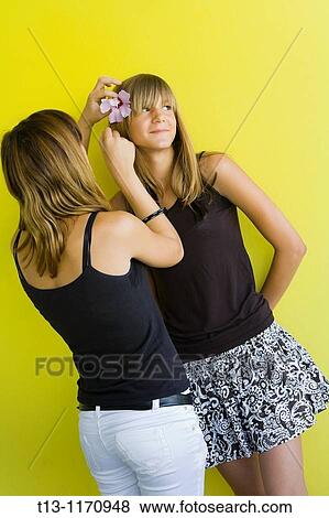 Putting a flower on her hair View Large Photo Image Stock Photo - Putting a flower on her hair. Fotosearch