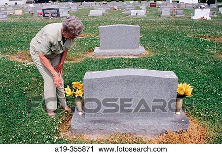 Putting Flowers On A Grave For A Special Occasion Stock Image A19 355871 Fotosearch