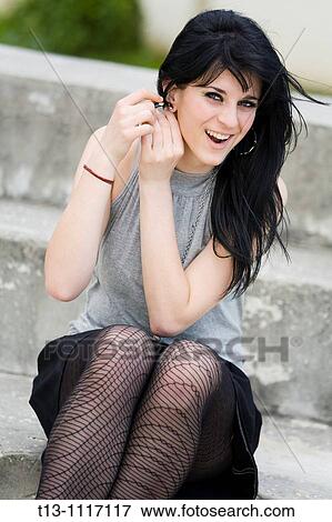 Putting on earring View Large Photo Image Stock Photo - Putting on earring. Fotosearch