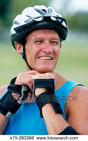putting on his bicycle helmet View Large Photo Image Stock Photo - putting on his bicycle helmet. Fotosearch