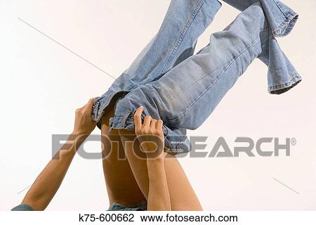 Stock Image - Putting on jeans. Fotosearch