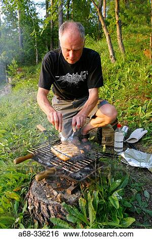 Putting salmon on the grill. Sweden View Large Photo Image Stock Photograph - Putting salmon on the grill. Sweden. Fotosearch