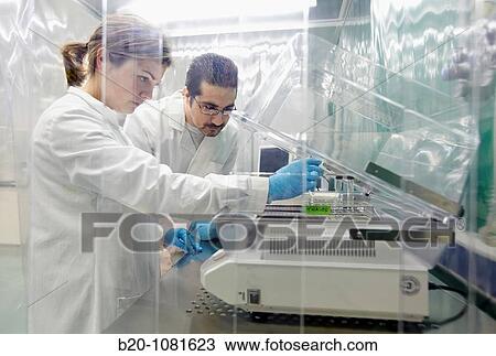 Stock Image - Putting sample in stirrer, laminar flow cabinet, Synthesis Laboratory, CIC nanoGUNE Nanoscience Cooperative Research Center, Donostia, Gipuzkoa, Euskadi, Spain. Fotosearch