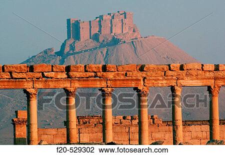Stock Image - Qalaat ibn Maan castle (17th Century) above ruins of Palmyra. Syria. Fotosearch