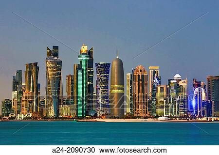 Stock Image - Qatar, Doha City, The Corniche, West Bay Skyline at sunset.. Fotosearch