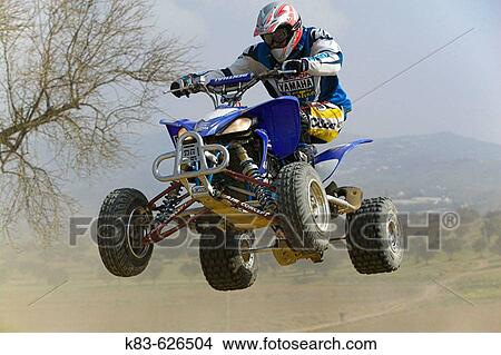 Quad jumping. View Large Photo Image Picture - Quad jumping.. Fotosearch