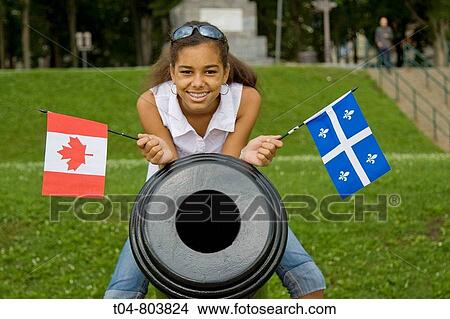 Quebec City, Canada - 12-year-old biracial girl with the flags of Canada and Quebec Model Release Available View Large Photo Image Picture - Quebec City, Canada - 12-year-old biracial girl with the flags of Canada and Quebec Model Release Available. Fotosearch