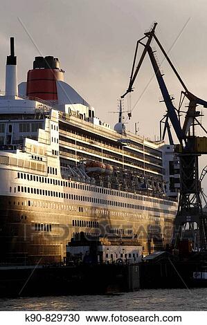 Queen Mary II laying in the dry dock of a Blohm & Voss shipyard in Hamburg, Germany, Europe View Large Photo Image Stock Image - Queen Mary II laying in the dry dock of a Blohm & Voss shipyard in Hamburg, Germany, Europe. Fotosearch