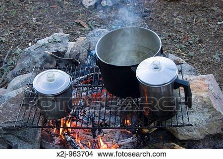 Quetico Provincial Park, Ontario - Pots on a cooking fire during a canoe camping trip View Large Photo Image Picture - Quetico Provincial Park, Ontario - Pots on a cooking fire during a canoe camping trip. Fotosearch