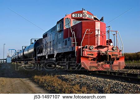 Stock Photo - Rail tank cars being filled with ethanol for shipment from ethanol plant, Richardton, North Dakota. Fotosearch