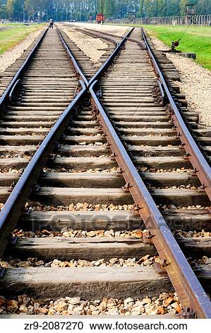 Stock Image - Railroad tracks inside Auschwitz II Birkenau concentration camp leading to gas chambers, Oswiecim, Poland, Europe.. Fotosearch