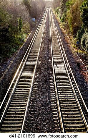 Stock Photograph - Railway lines pair recede into distance.. Fotosearch