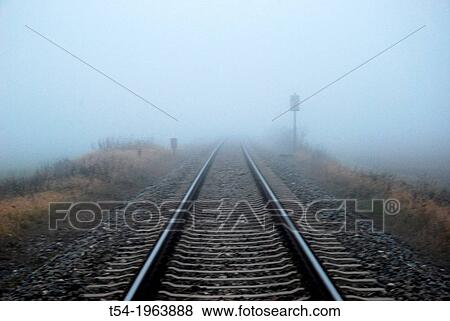 Stock Photo - Railway tracks in the fog.. Fotosearch