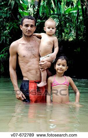 Stock Photo - Raimundo Queiroz and children, in Baliza, Santar? m. During the weekends they go to the Amazonas tributaries, where there are spas. Brazil.. Fotosearch