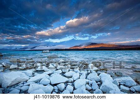 Rain clouds gather at dusk, Lake Tekapo, Mackenzie country, South Island, New Zealand. View Large Photo Image Stock Photograph - Rain clouds gather at dusk, Lake Tekapo, Mackenzie country, South Island, New Zealand.. Fotosearch