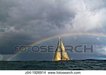 Picture - Rainbow at sea and Sail boat at Bay of Biscay, Spain. Fotosearch