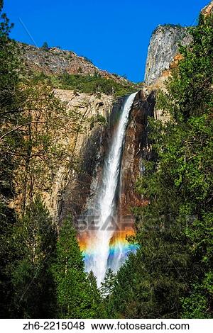 Stock Photo - Rainbow over Bridalveil Fall, Yosemite National Park, California USA.. Fotosearch