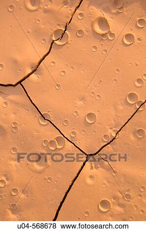 Raindrop craters in baked desert soil near Moab, Utah, USA. View Large Photo Image Stock Photo - Raindrop craters in baked desert soil near Moab, Utah, USA.. Fotosearch
