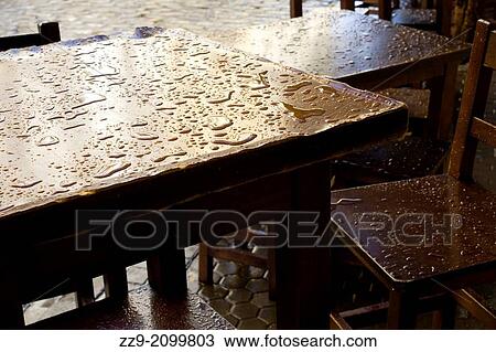 Stock Image - Raindrops on a wooden table.. Fotosearch