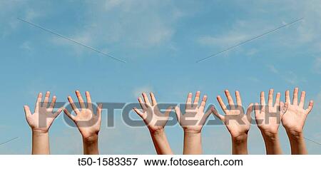 Raised hands against blue sky View Large Photo Image Stock Photo - Raised hands against blue sky. Fotosearch