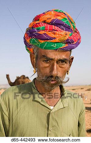 Stock Image - Rajasthani Camel Seller. Pushkar camel fair. Pushkar. Rajasthan. India.. Fotosearch