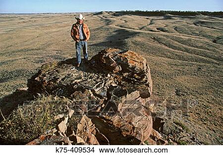 Rancher on top of a butte in eastern Montana View Large Photo Image Picture - Rancher on top of a butte in eastern Montana. Fotosearch