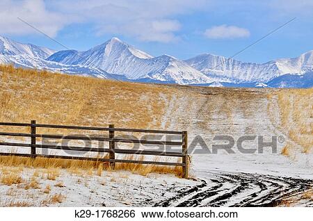 Ranchland fence and road with a backfrop of the Crazy Mountain Range, Bozeman, Montana, USA View Large Photo Image Stock Photograph - Ranchland fence and road with a backfrop of the Crazy Mountain Range, Bozeman, Montana, USA. Fotosearch