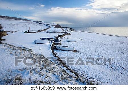 Rare occurance of Snow covered Chesil Beach and Boats at Burton Bradstock Dorset View Large Photo Image Stock Photo - Rare occurance of Snow covered Chesil Beach and Boats at Burton Bradstock Dorset. Fotosearch