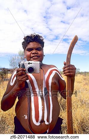 Rare Photograph of painted Aboriginal Boy with camera in the Outback Australia. View Large Photo Image Stock Photo - Rare Photograph of painted Aboriginal Boy with camera in the Outback Australia.. Fotosearch