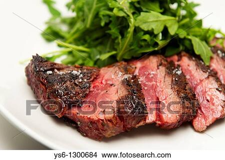Rare Sliced Steak and Arugula on a White Plate View Large Photo Image Picture - Rare Sliced Steak and Arugula on a White Plate. Fotosearch