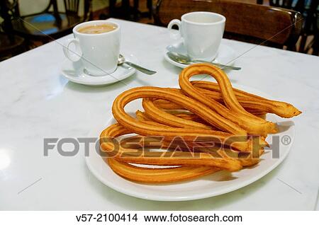 Ration of churros with two cups of coffee. Madrid, Spain. View Large Photo Image Picture - Ration of churros with two cups of coffee. Madrid, Spain.. Fotosearch