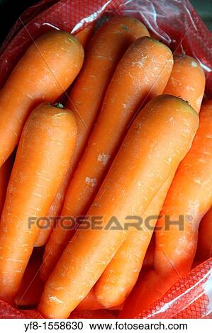 Stock Image - Raw carrots, Bolhao old market in Porto, Portugal. Fotosearch