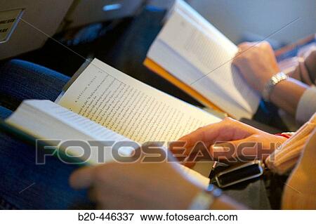 Reading a book during flight View Large Photo Image Stock Photo - Reading a book during flight. Fotosearch