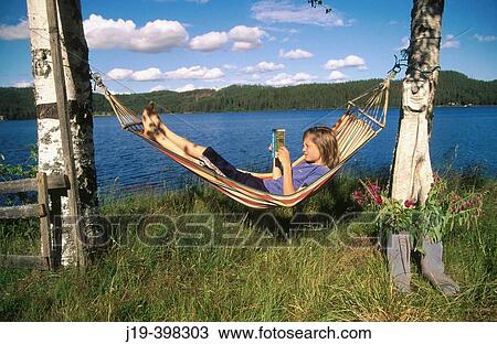 Reading a book in the hammock. Sweden View Large Photo Image Stock Image - Reading a book in the hammock. Sweden. Fotosearch